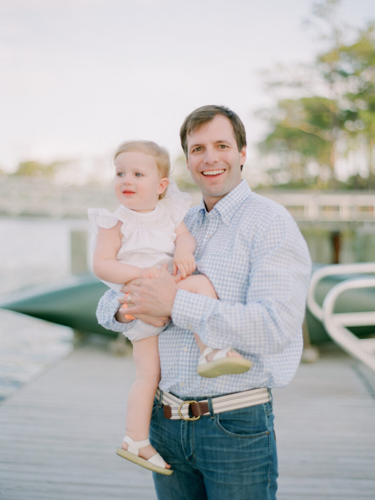 A father holds his little girl at the boathouse in Watercolor, Florida. 