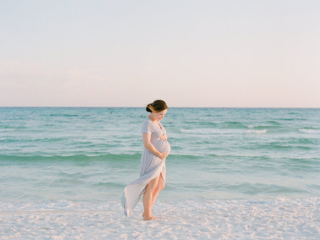 A pink sunset and an expecting mom captured in 30A by Watercolor photographers, Kaylie B. Poplin. 
