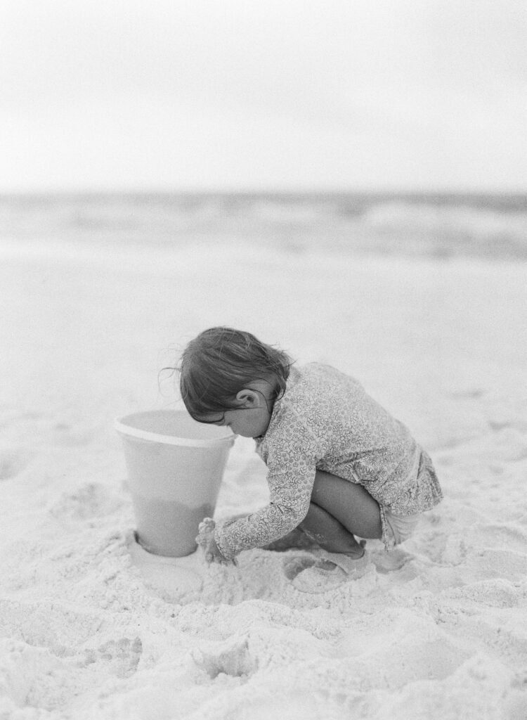 A little girl builds sand castles on the beach in Destin, Florida. 