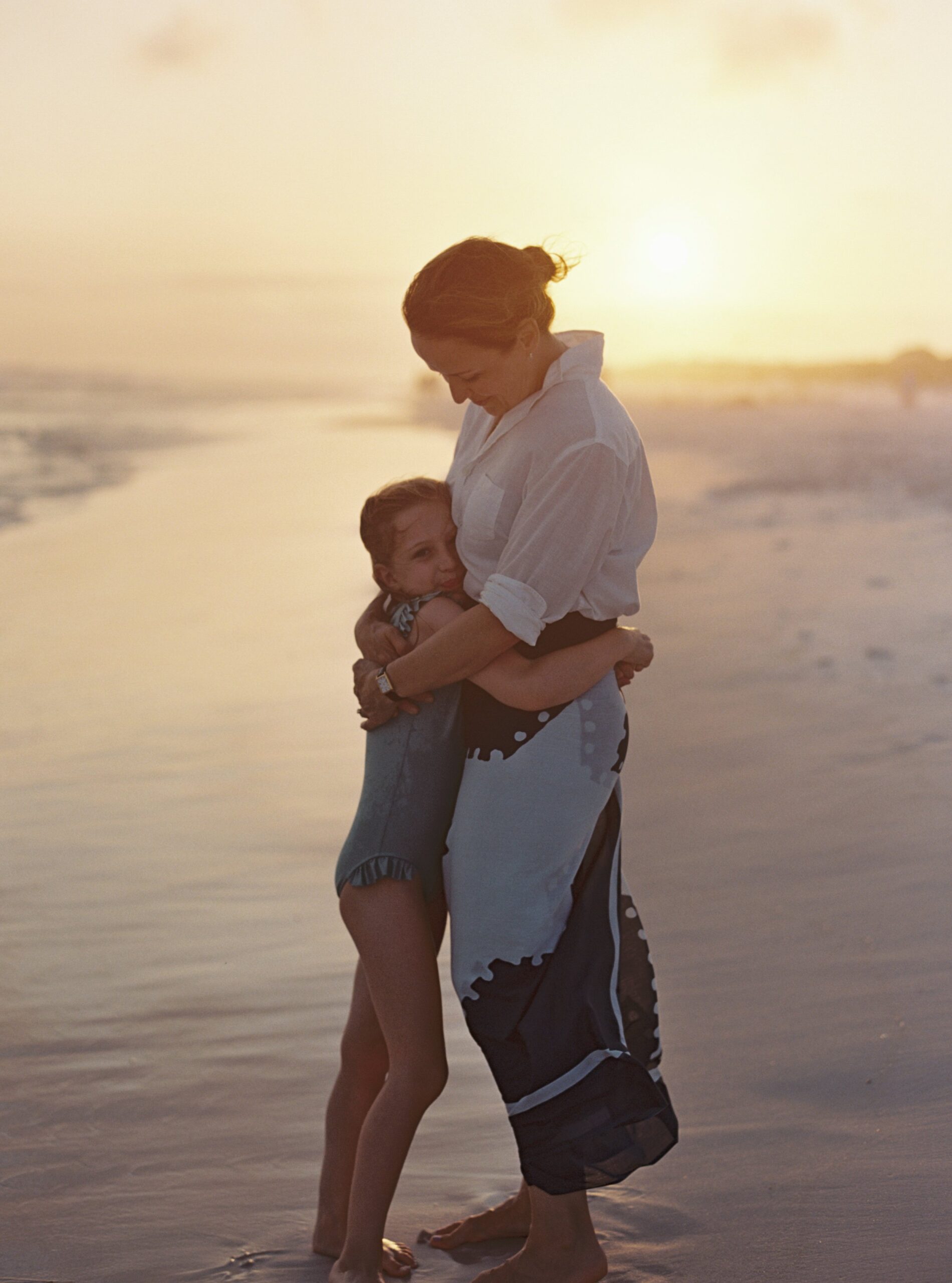 A mother and her daughter on the beach during sunset in Seaside, Florida.