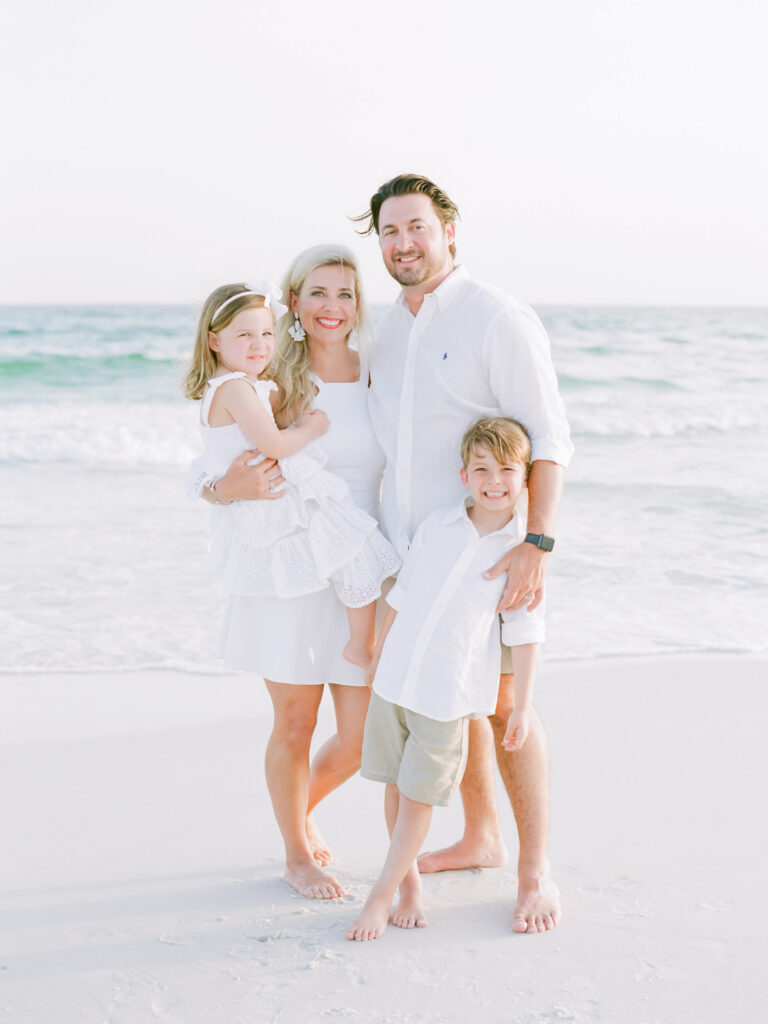 A family being photographed by photographers in Santa Rosa Beach FL, Kaylie B. Poplin Photography. 