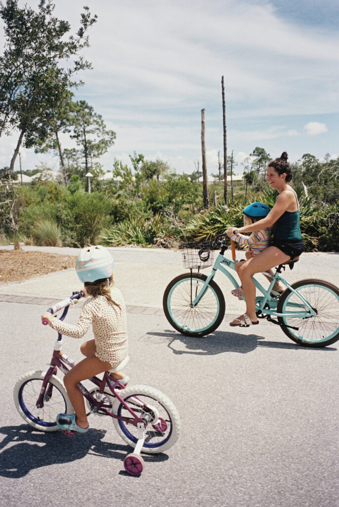 A woman with two girls riding bikes in port st joe florida on the forgotten coast of florida. 