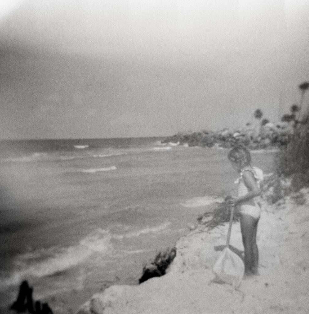 A little girl overlooks beach erosion 
 near the cape san blas lighthouse on cape san blas, florida. 