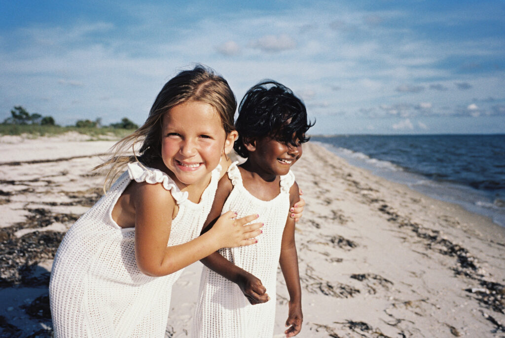 Two sisters playing on the beach on the forgotten coast of florida. 