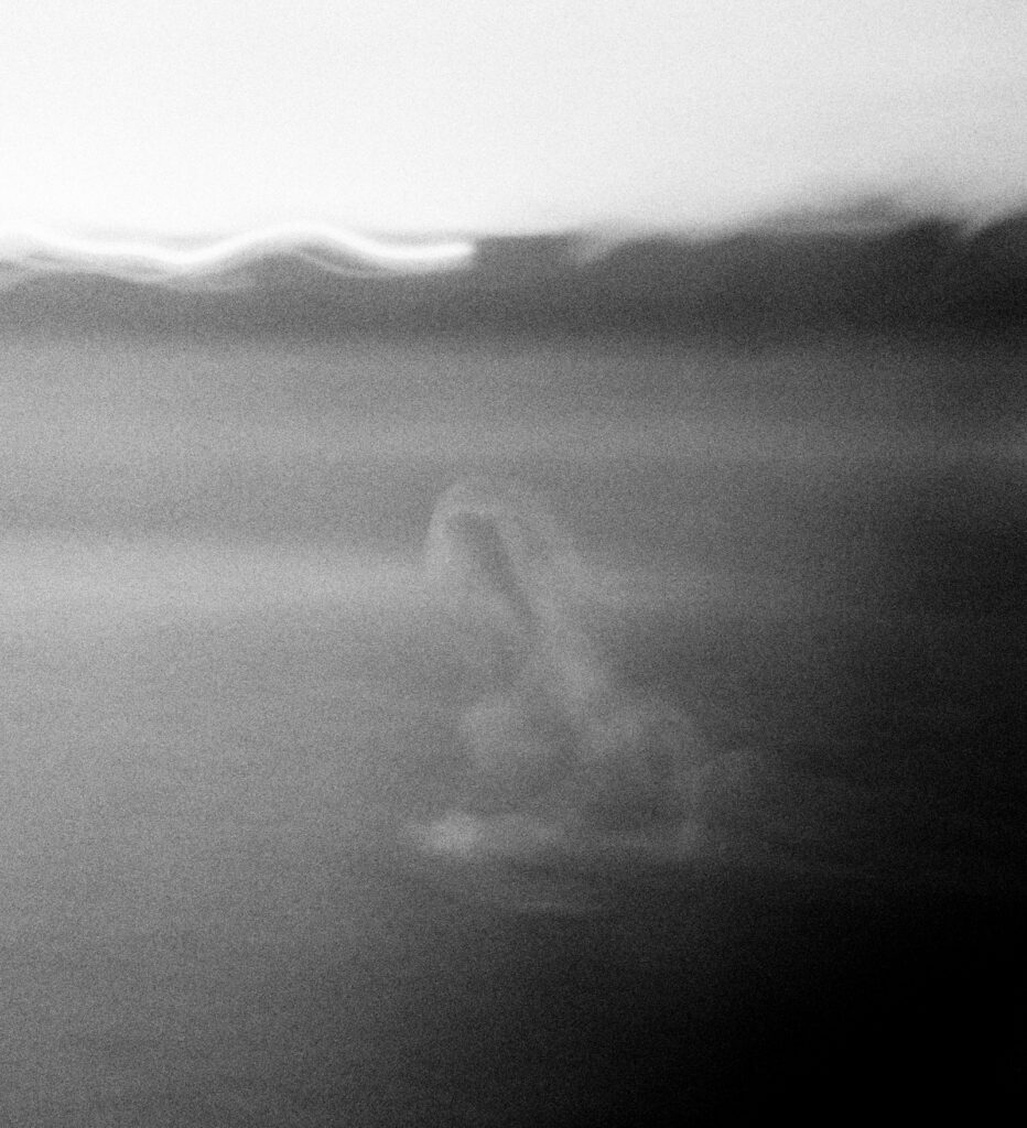A blurred photo of a girl running barefoot across the lawn. 