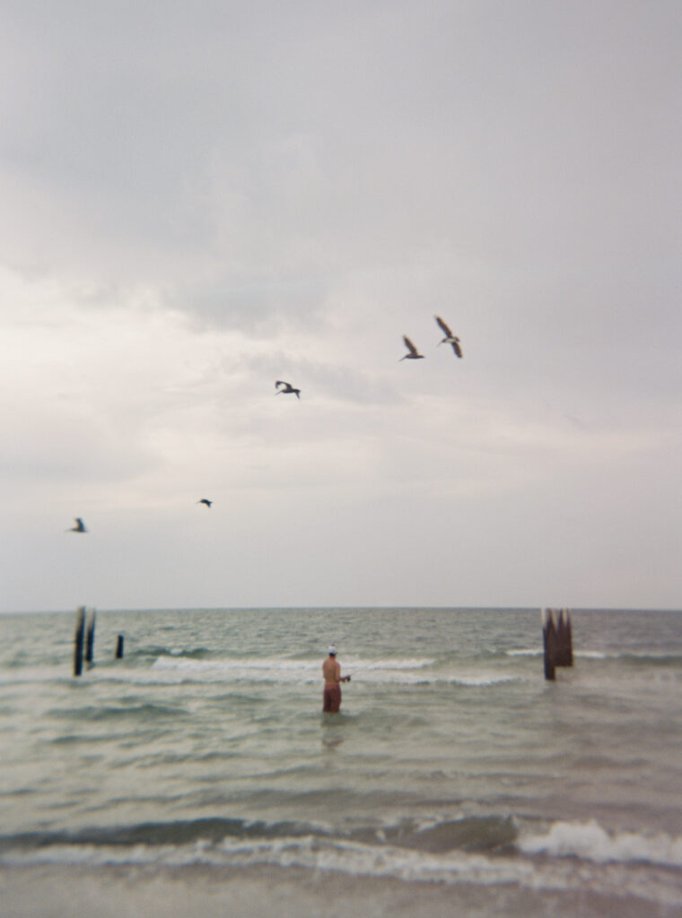 A fisherman fishes at driftwood beach in Cape San Blas, Florida. 