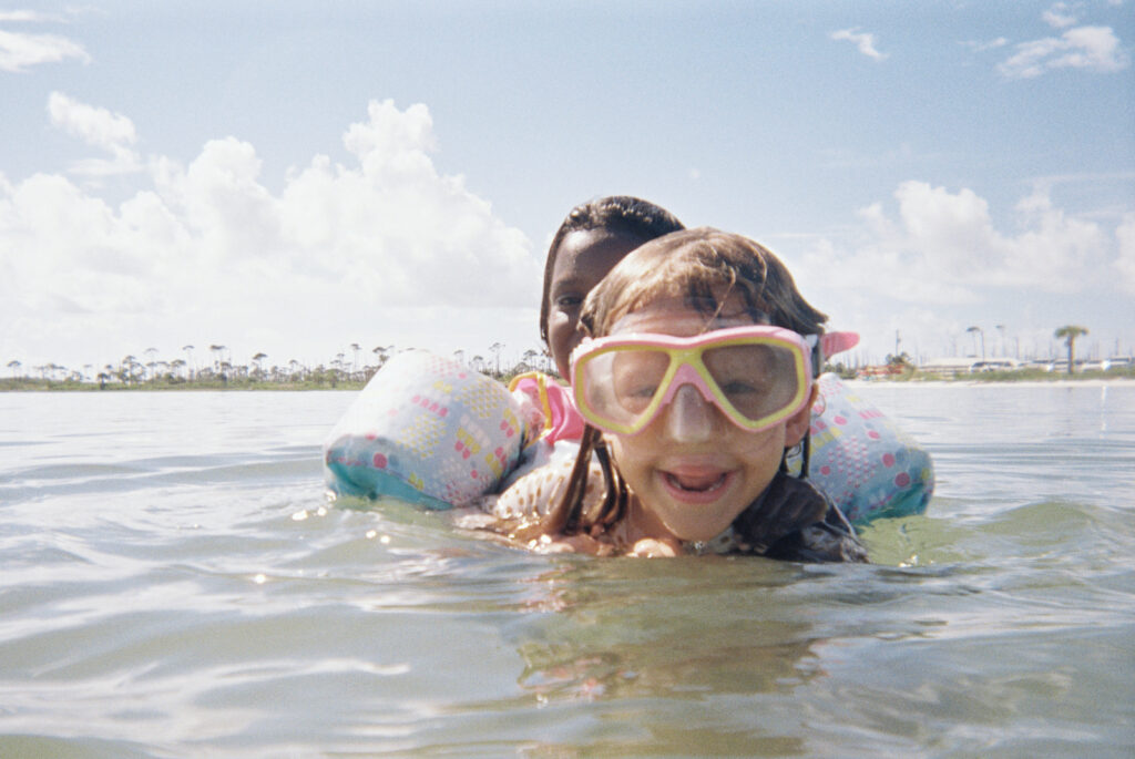 Two kids swim with goggles on in the Cape San Blas State Park.