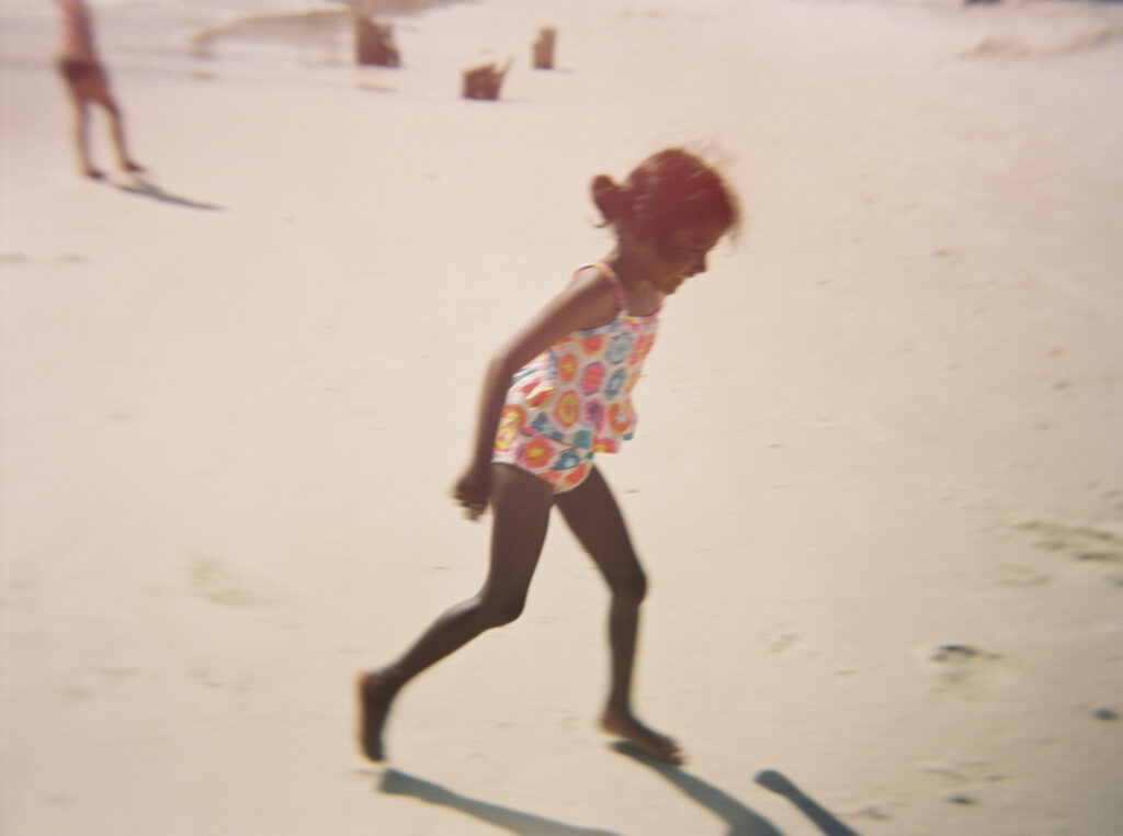 A young kid runs on Driftwood beach in Cape San Blas Florida. 