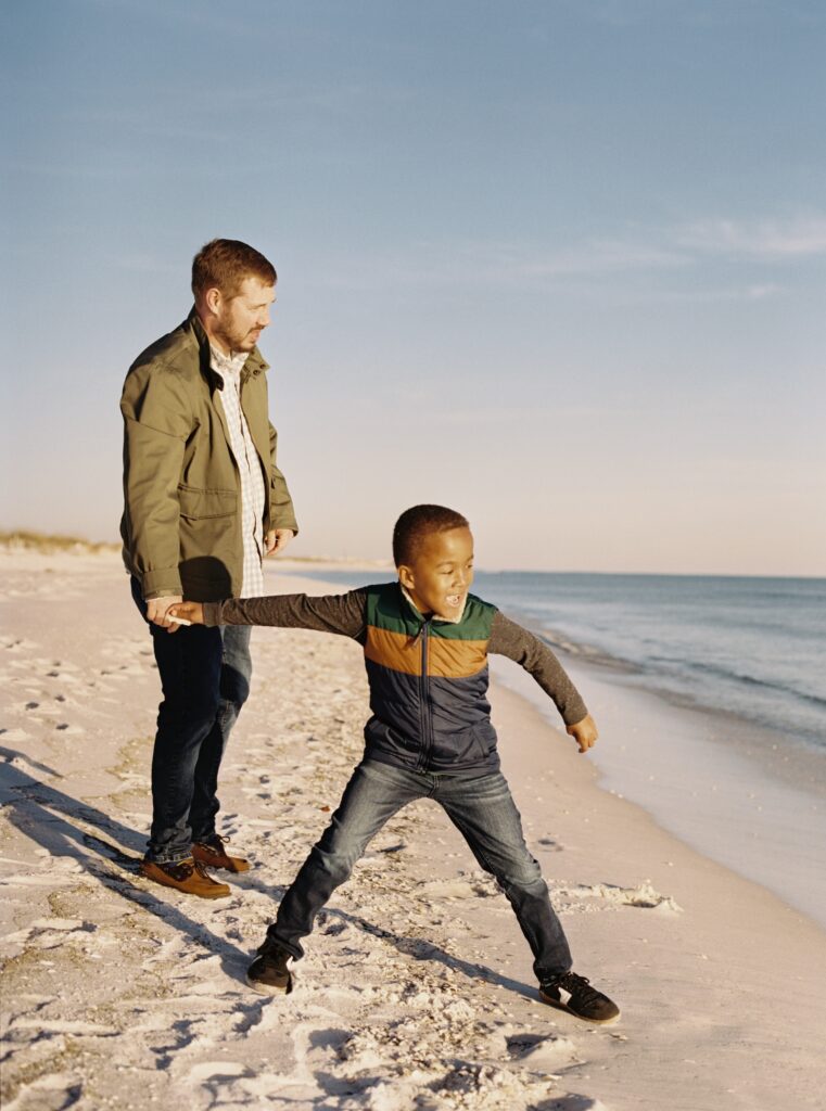 A son and his father skip shells on the water on Okaloosa Island in Destin, FL. 