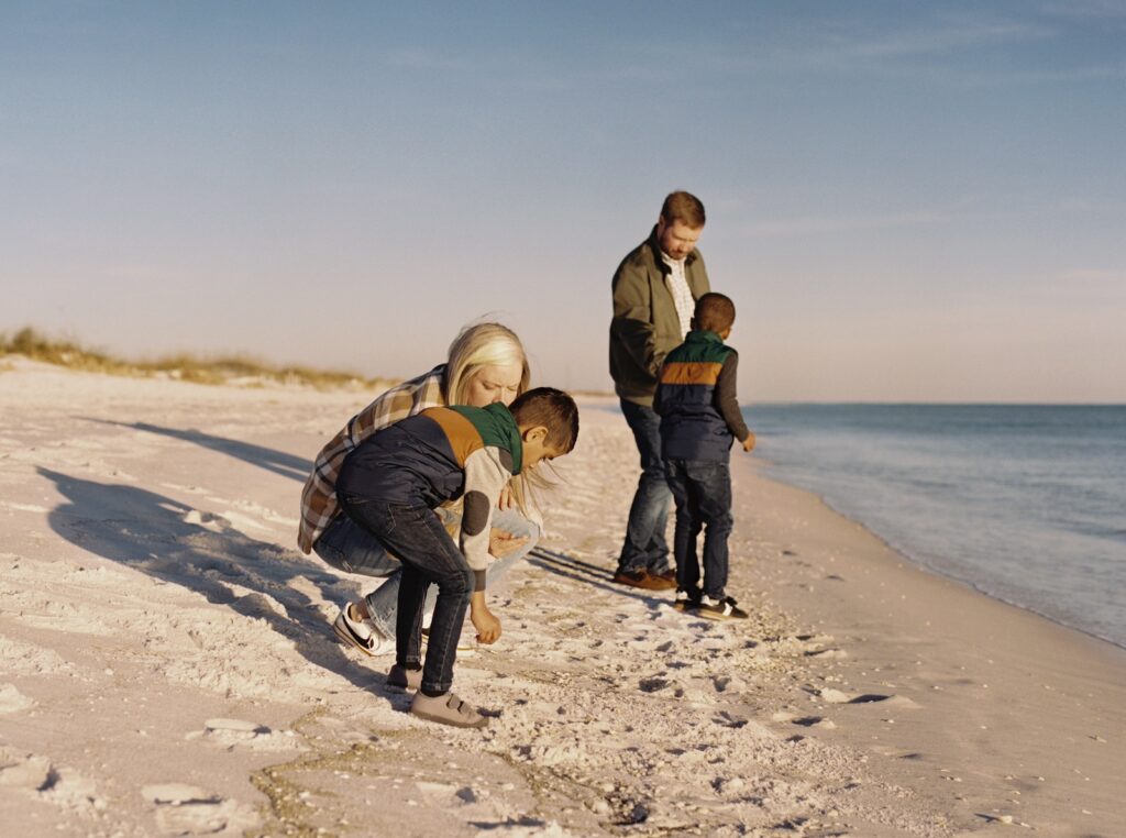 A family skips shells on the beach in Destin, Florida. 