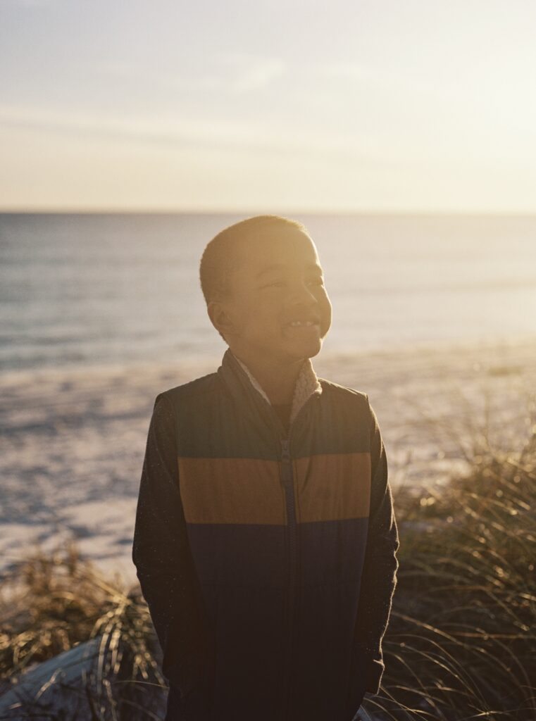 A boy smiling during sunset in Destin, FL. 